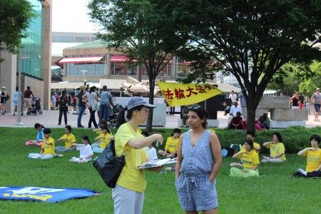 图5：法轮功学员在巴尔的摩市内港旅游区展示五套功法，同时向过往游客讲述迫害真相。